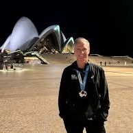 Why are running marathons important to Tom Hauser?