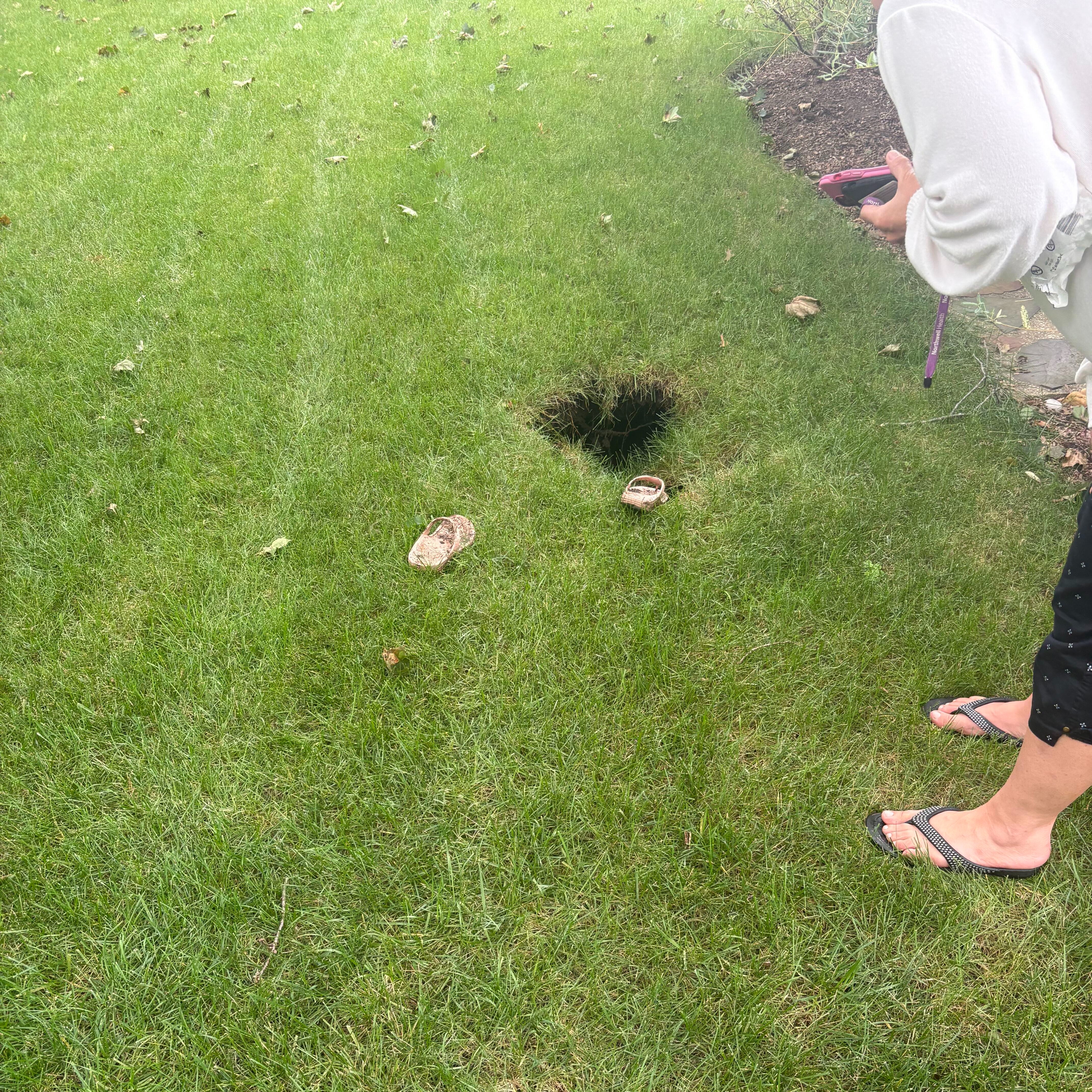 Long Island woman rescued from 8-foot hole in her backyard