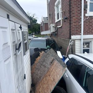 Car speeds through red light in Holmesburg, crashes into fence